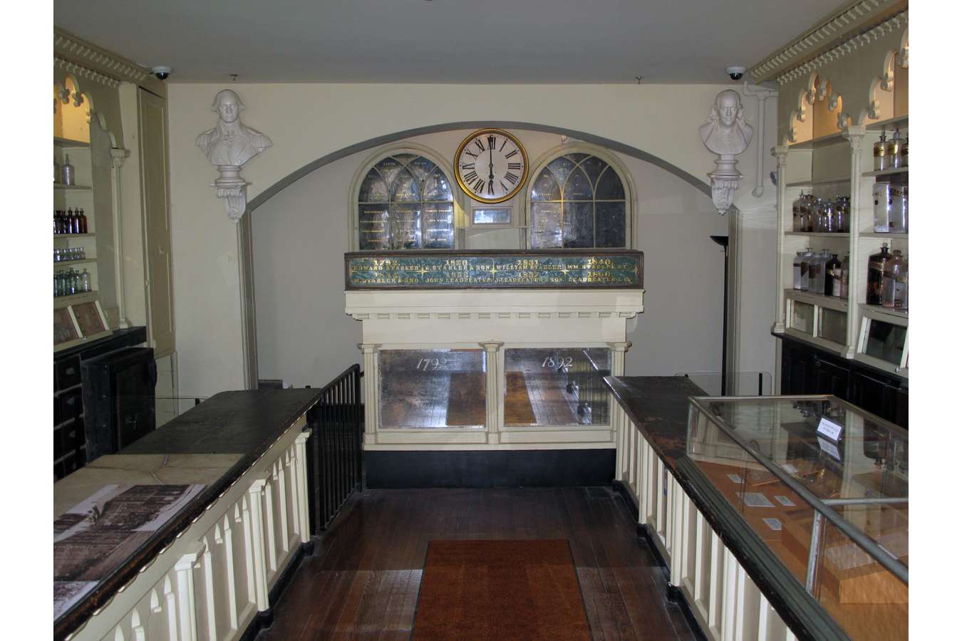 Apoth 7852 : Restored busts of George Washington and Ben Franklin and clock returned to arched wall